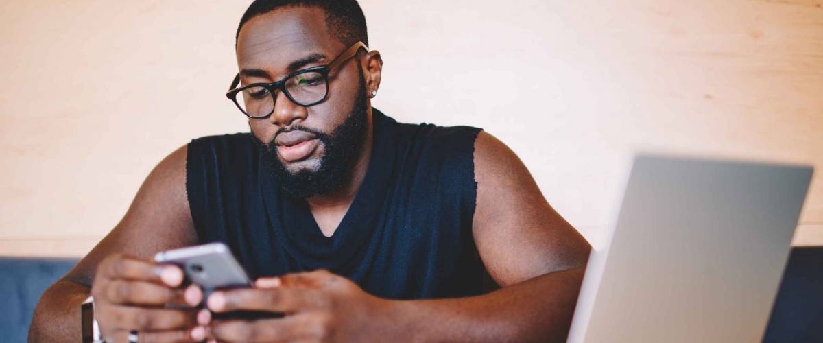 Serious african american male freelancer reading information