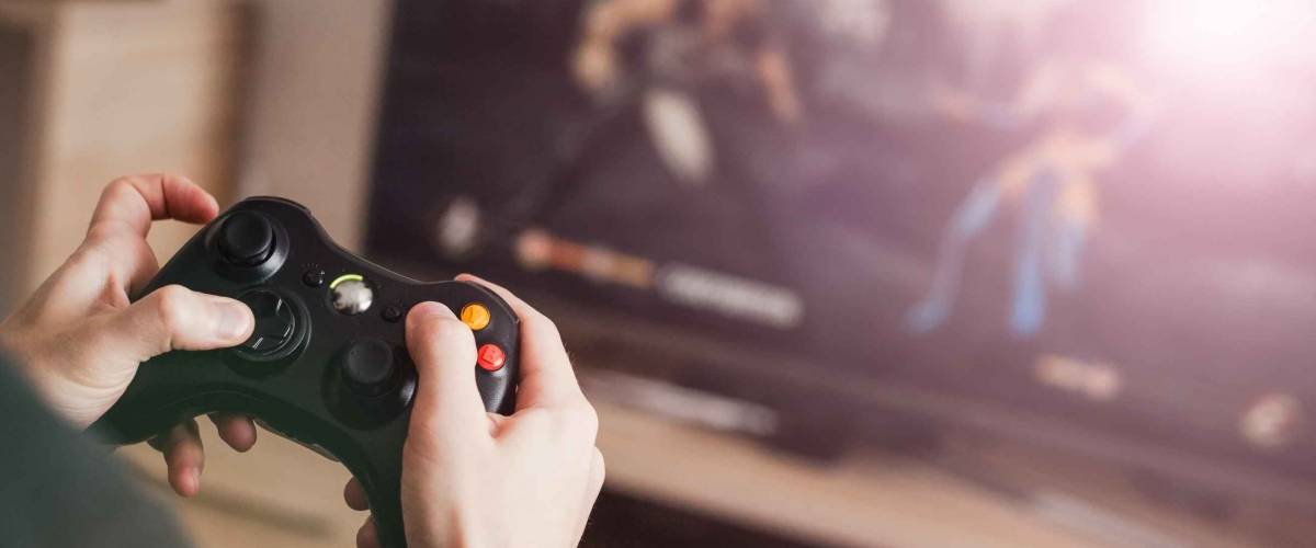The guy is playing on the console
