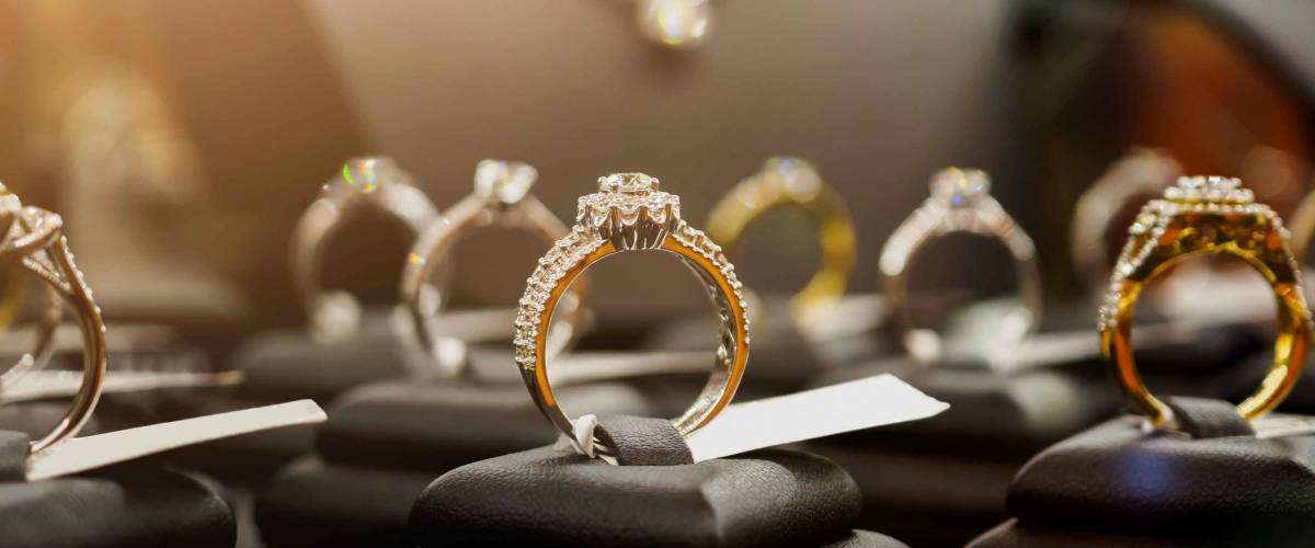 Jewelry diamond rings and necklaces show in luxury retail store window display showcase
