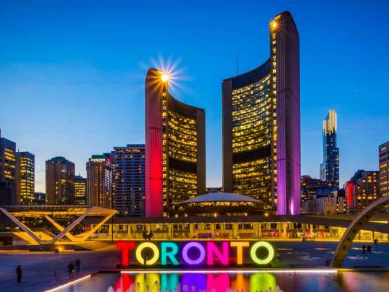 View of Nathan Phillips Square and Toronto Sign in downtown at night, in Toronto, Ontario.
