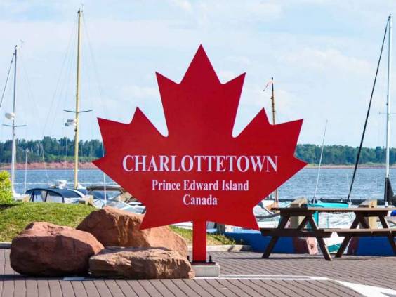 Charlottetown sign on the red maple leaf at the port harbor in Prince Edward Island, Canada.