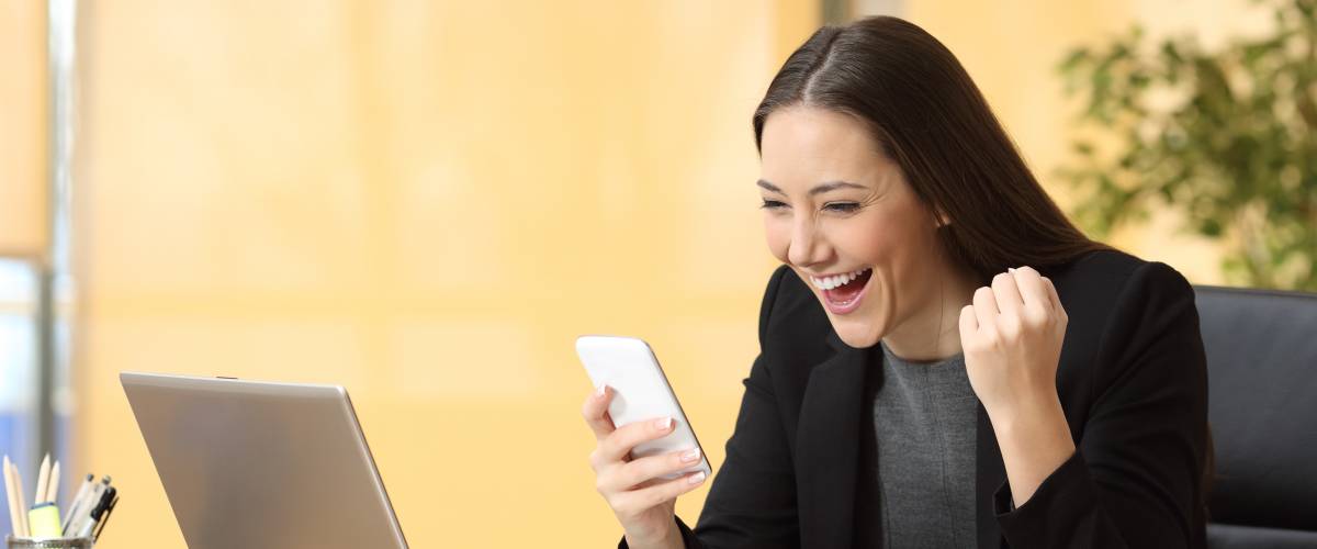 Excited woman checking phone