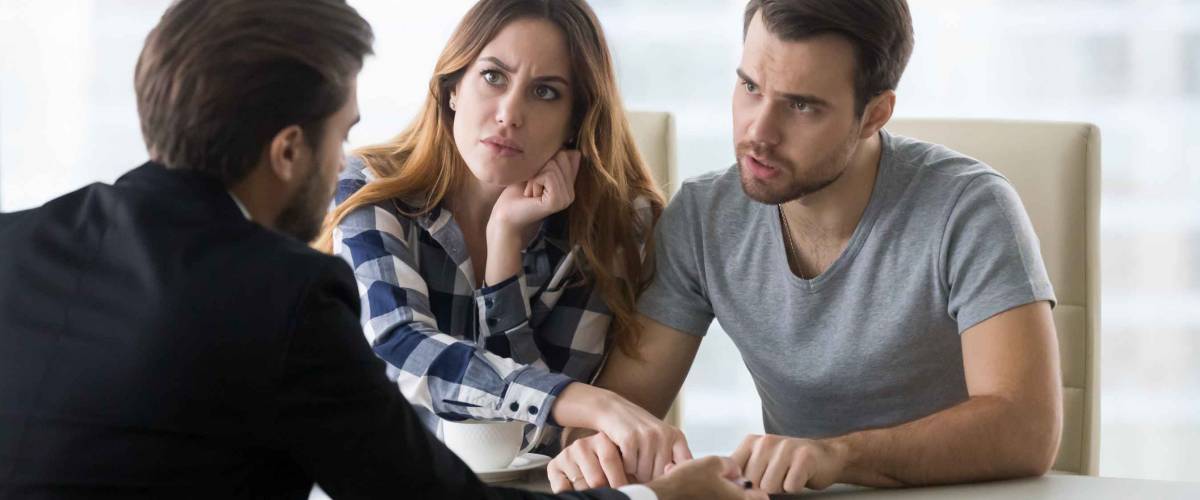 Dissatisfied couple arguing with insurer