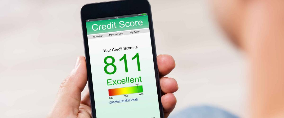 Man Holding Smart Phone Showing Credit Score Application On A Screen