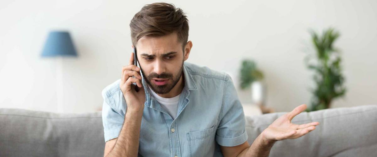 Angry man talking on phone.