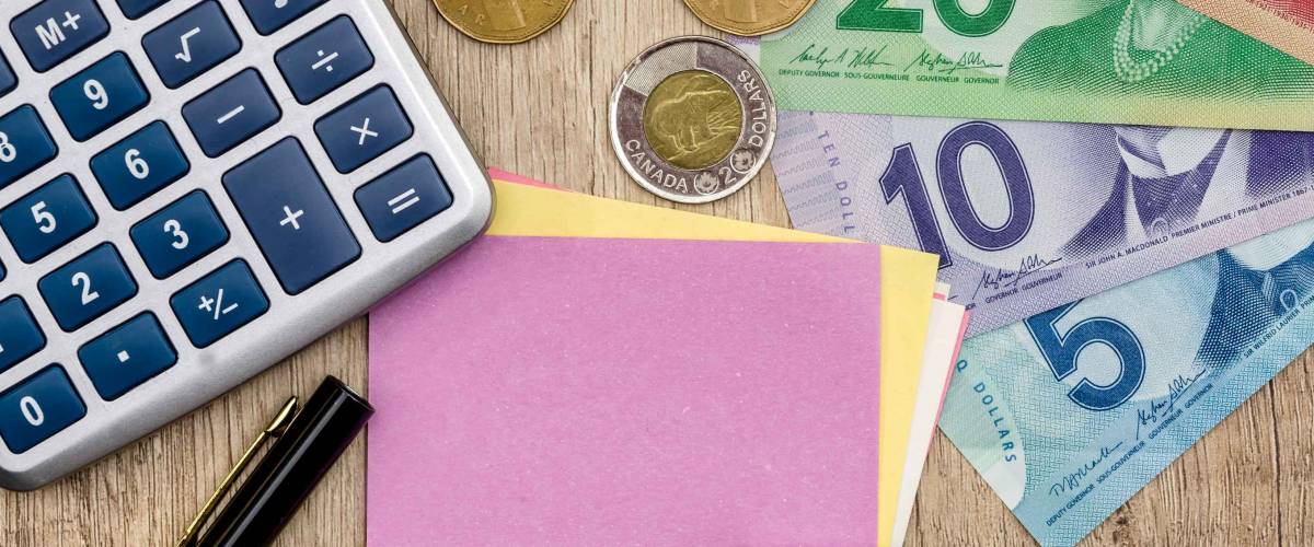 Canadian dollar with notepad pen and calculator