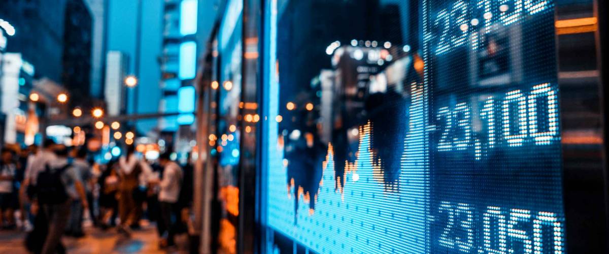 Display of Stock market quotes with city scene reflect on glass