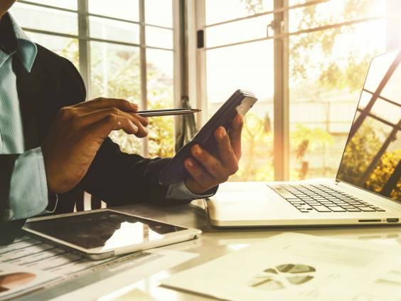 Business people sit and analyze The investment slate from the calculator with caution : Financial marketing and stock market jobs
