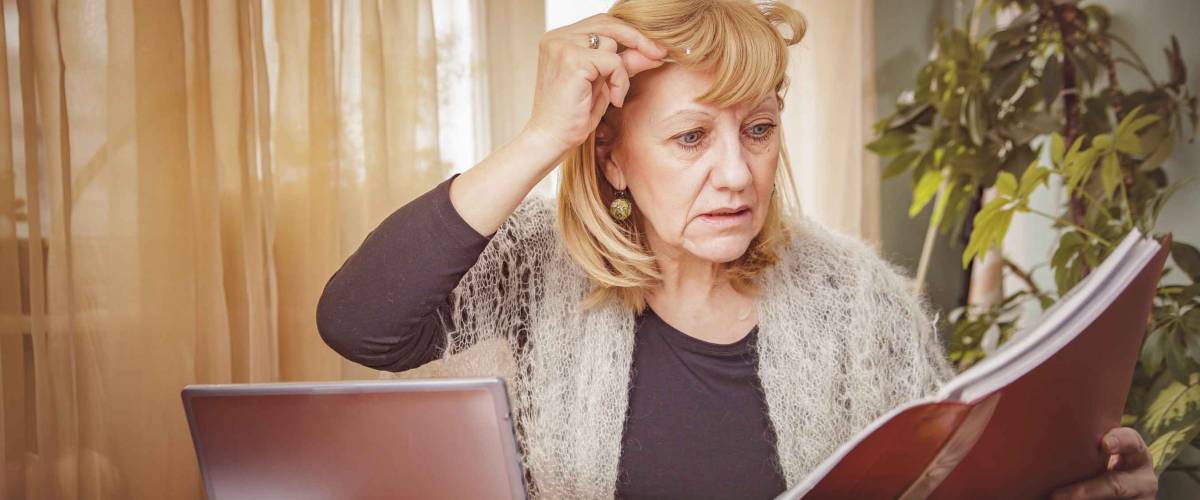 Senior blonde business woman unhappy with the numbers she's reviewing