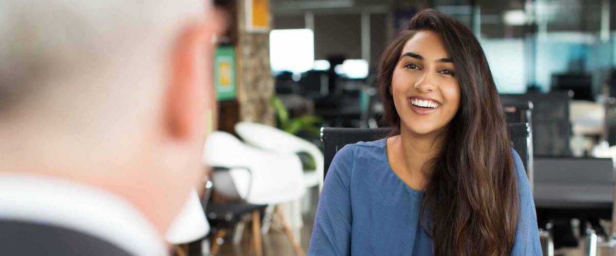 Young female candidate laughing at job interview