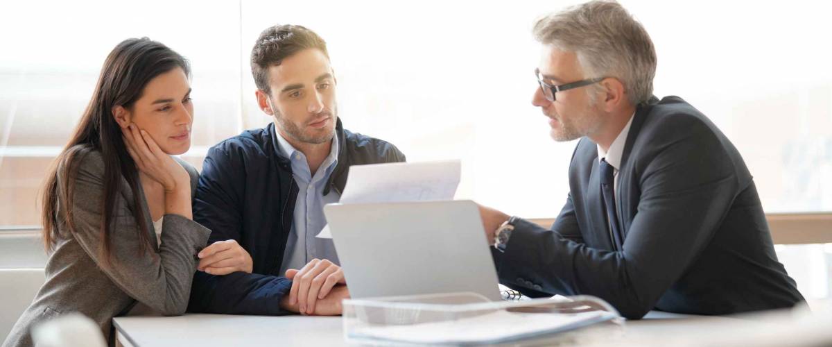 Young couple meeting financial advisor for home investment