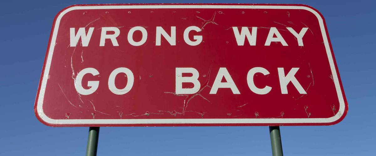 Wrong way go back road sign.