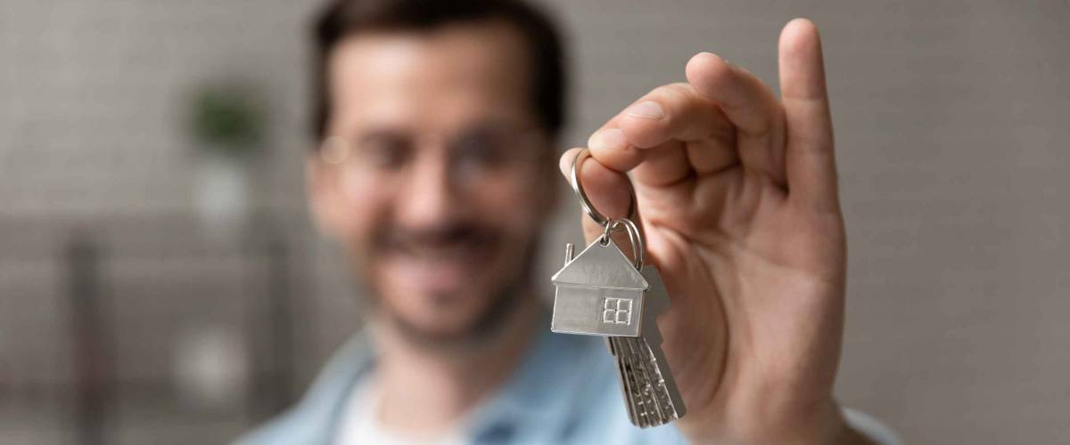 Satisfied homeowner holding keys.