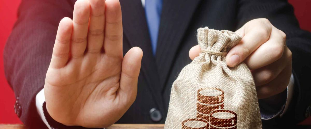 Businessman refuses to give money bag.