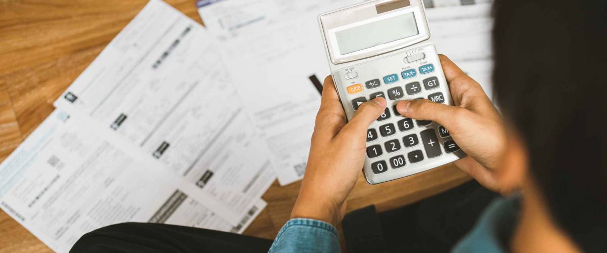 Top view man sitting on the floor stressed and confused by calculate expense from invoice or bill,