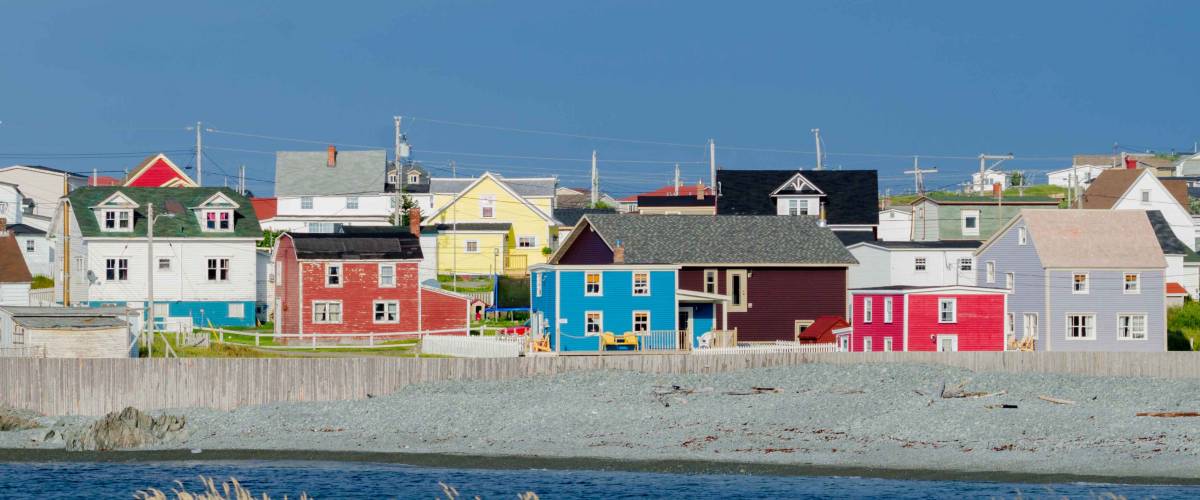 Small town with bright colored homes all over the coastal villages along the fingers of the Island of Newfoundland, Canada.