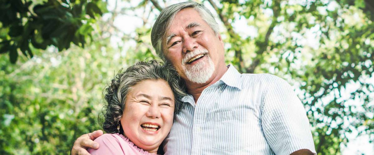 Happy elderly couple with lifestyle after retiree concept. Lovely asian seniors couple embracing together in the park in the morning.