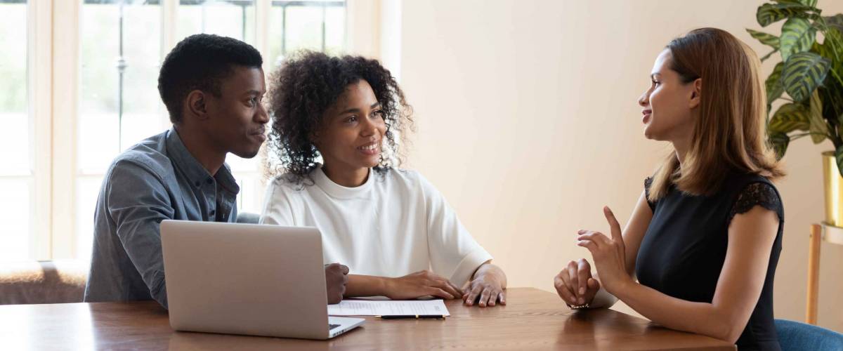 Female broker makes offer to young African ethnicity married couple