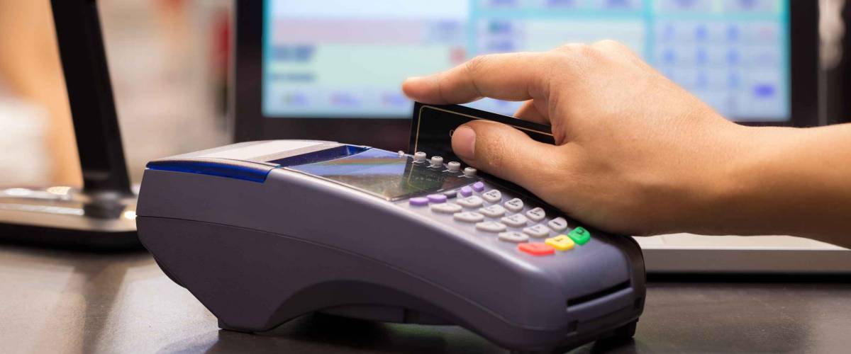 Hand Swiping Credit Card In Store