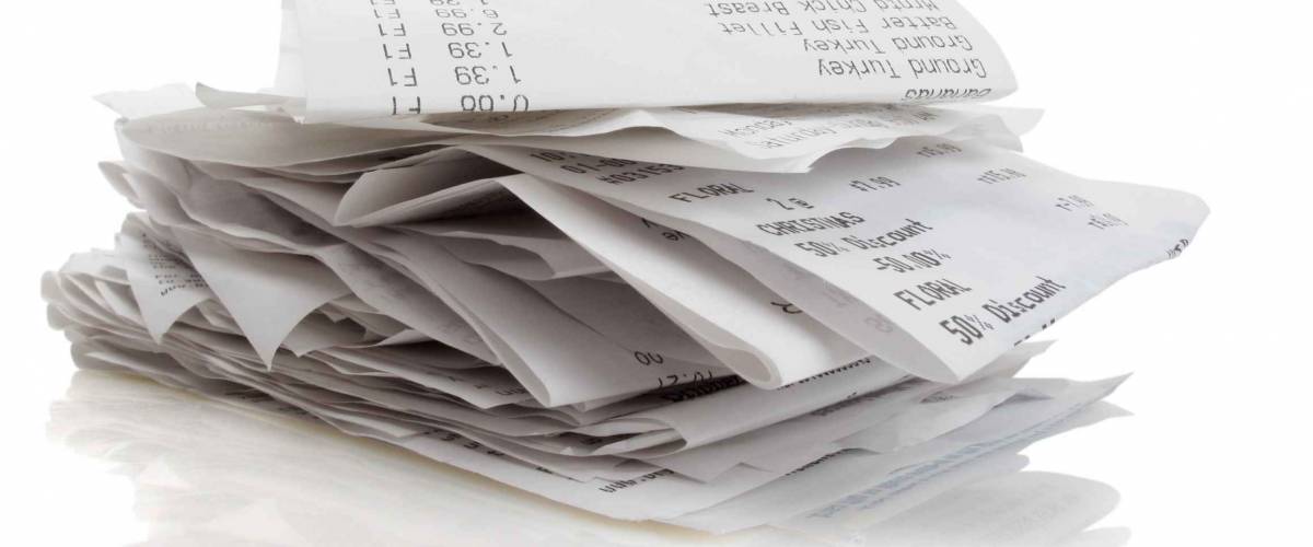 Stack of receipts piled high on white background