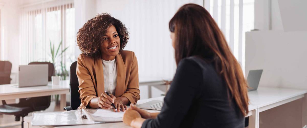Woman consulting with a female financial manager at the bank