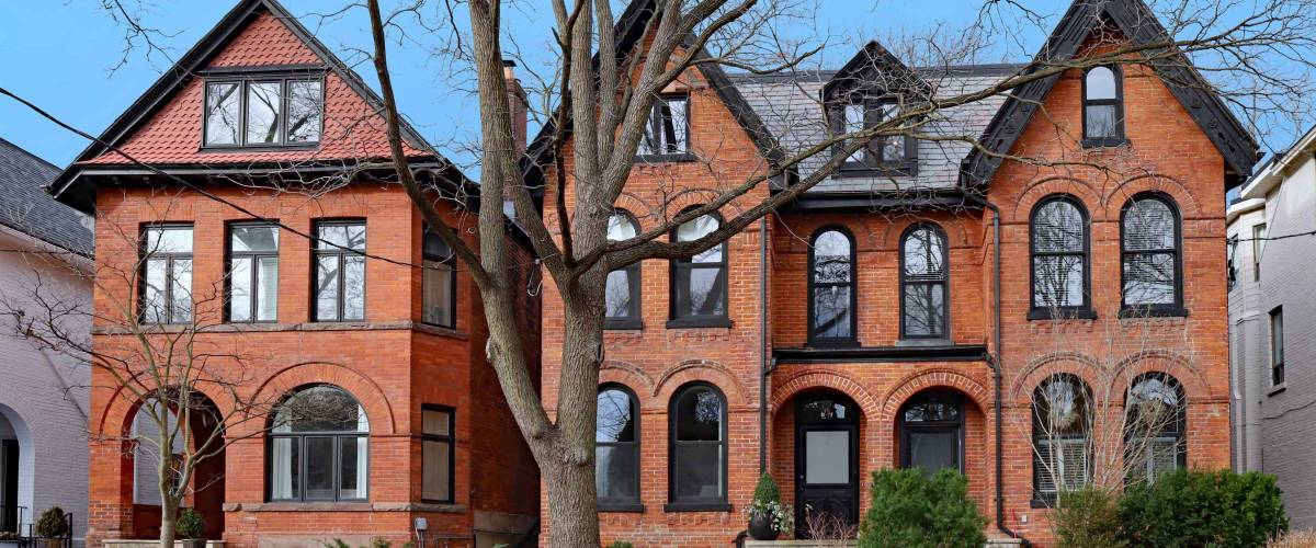 Street with large old brick houses with gables