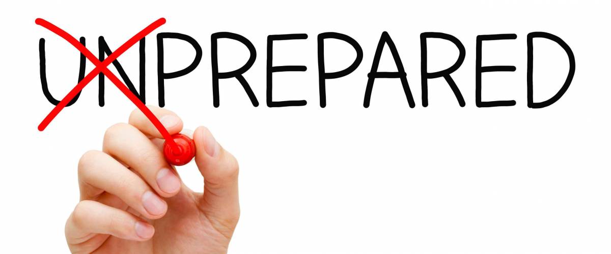 Hand turning the word Unprepared into Prepared with red marker isolated on white.