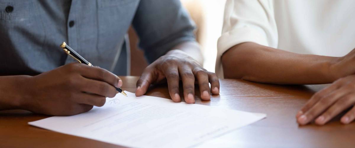 Horizontal image man holding pen put signature on agreement