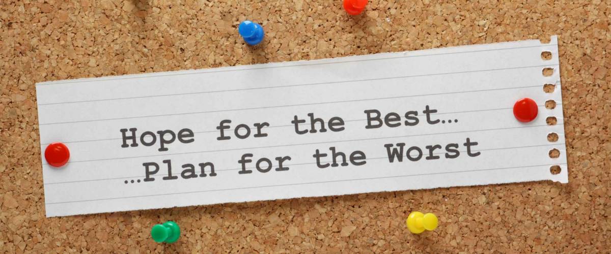 Hope For The Best and Plan for the Worst on a paper note pinned to a cork notice board