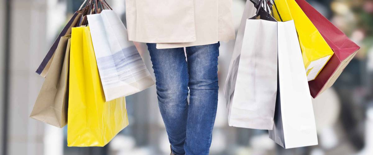 woman walking with shopping bags with christmas background.
