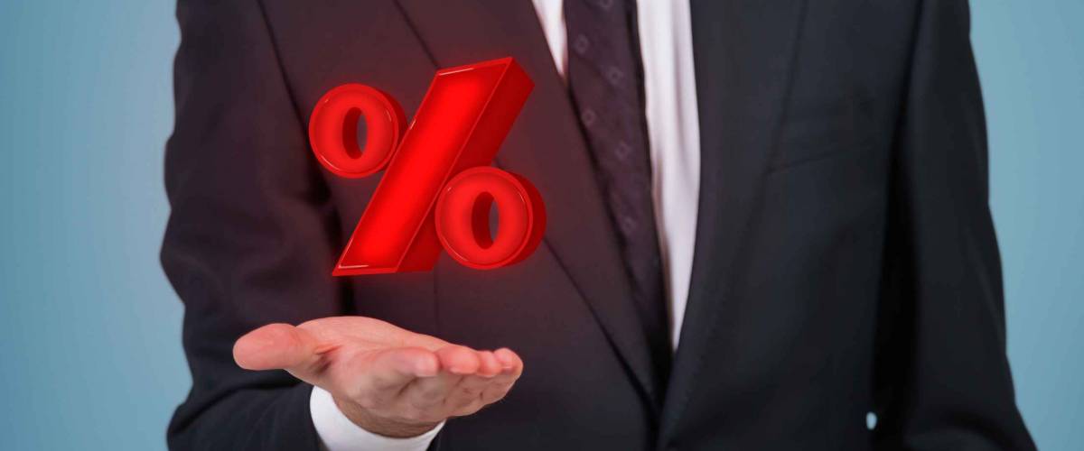 Businessman holding percentage mark
