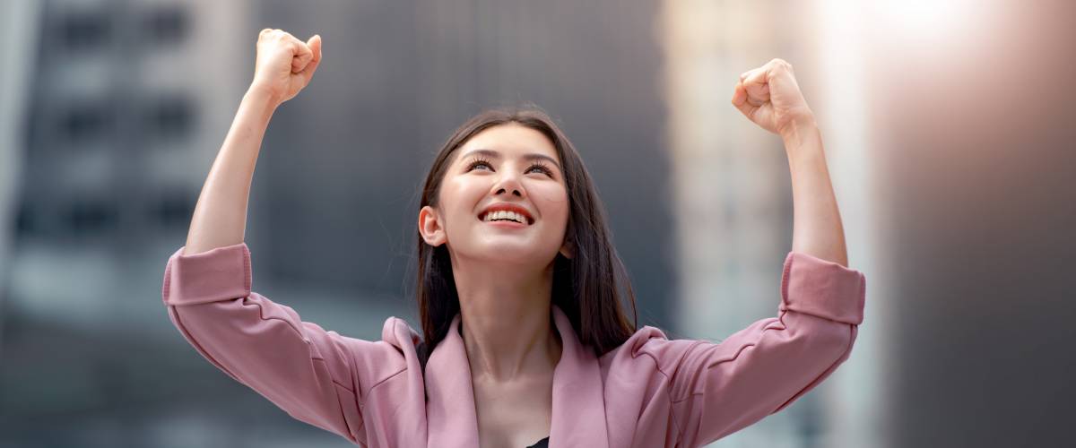 Asian woman happy about her raise