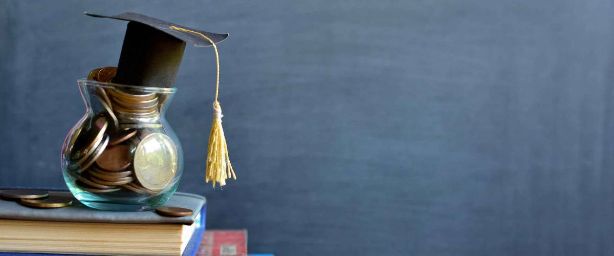 hat graduation model on money coins saving for concept investment education and scholarships