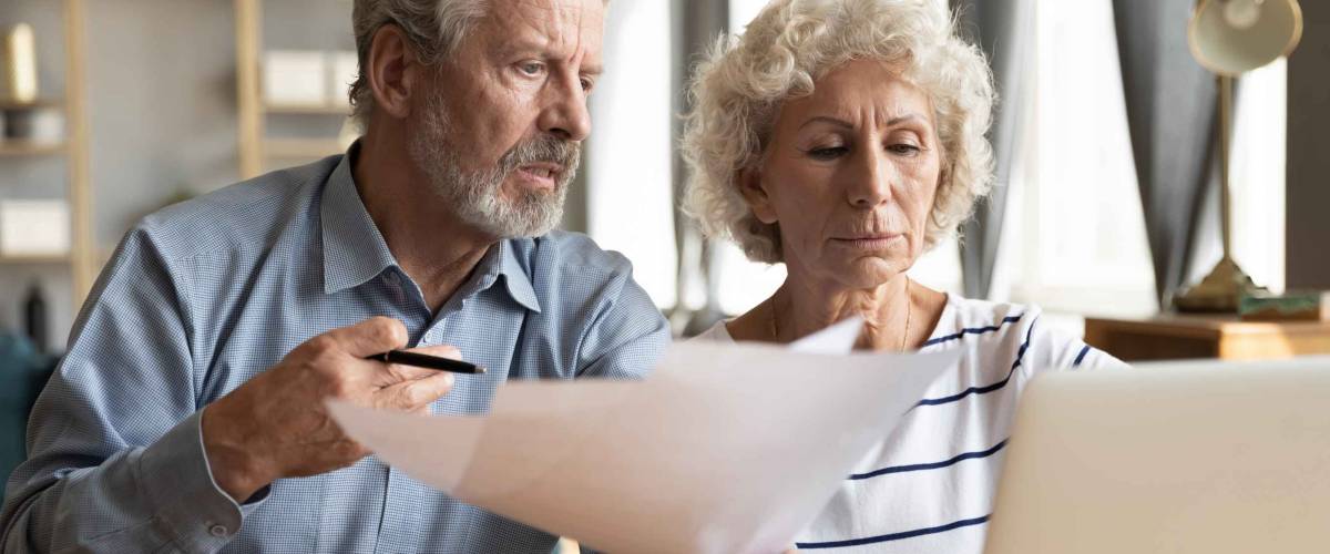 elderly couple worrying over finances