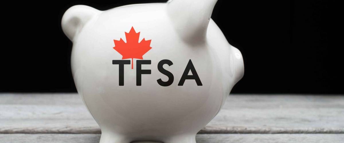 Canadian Tax-Free Savings Account concept with a piggy bank against black background