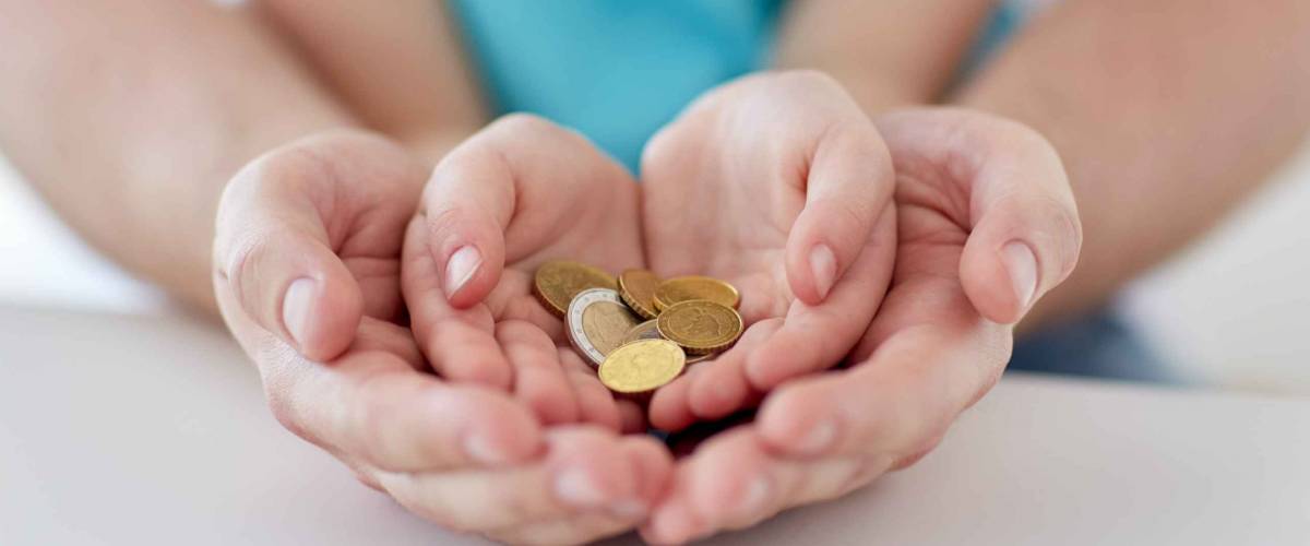 family, children, money, investments and people concept - close up of father and daughter hands holding euro money coins