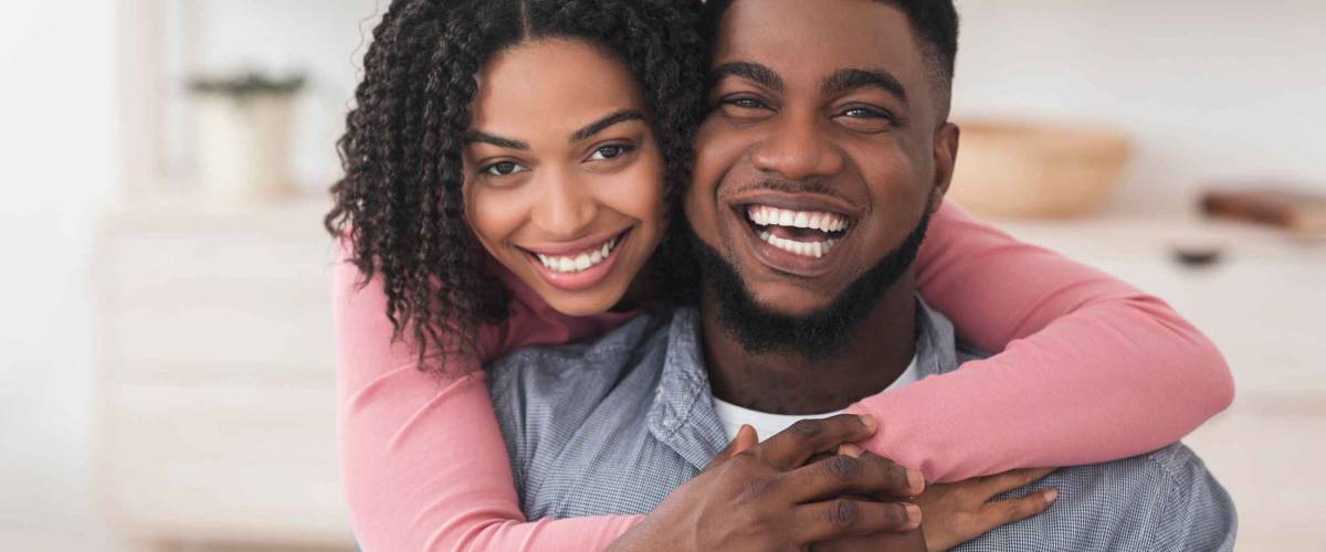 Portrait Of Loving African American Couple Hugging At Home And Looking At Camera, Spending Quarantine Together
