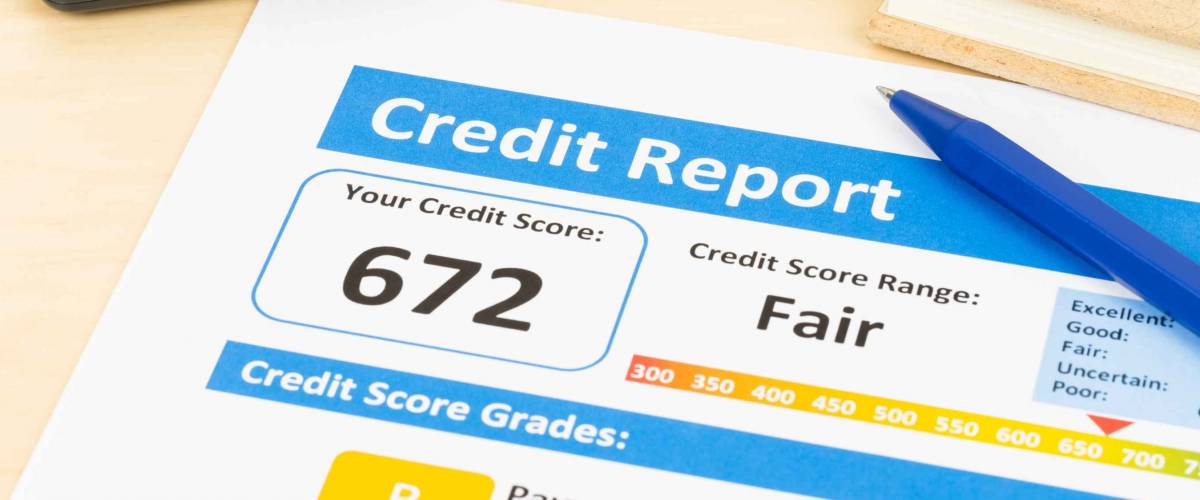 Fair credit score report with pen and calculator