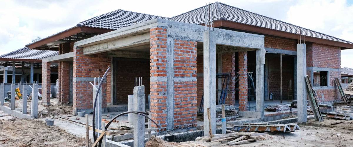 Unfinished single one storey house in housing estate. House construction.