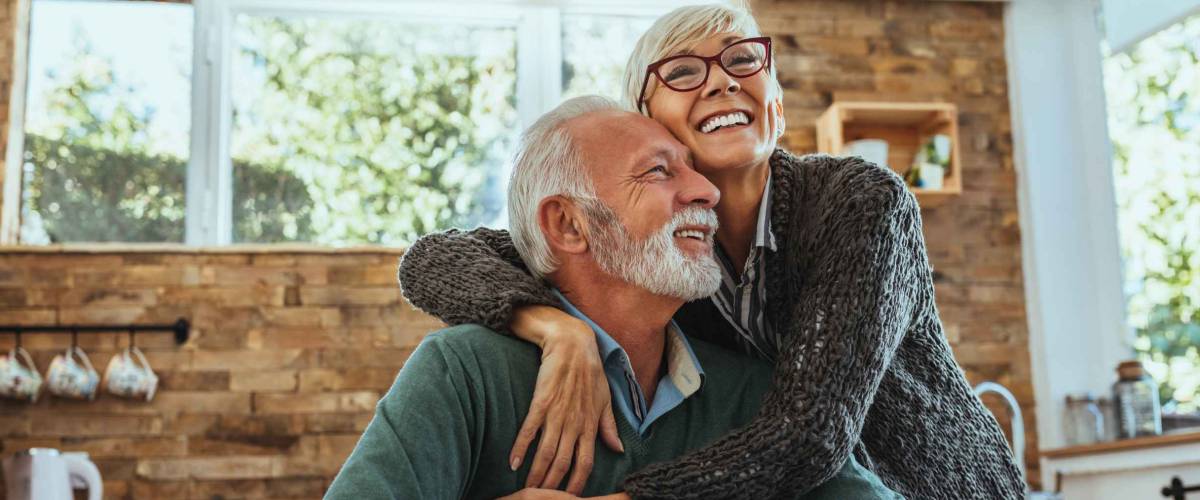 Mature woman hugging her husband