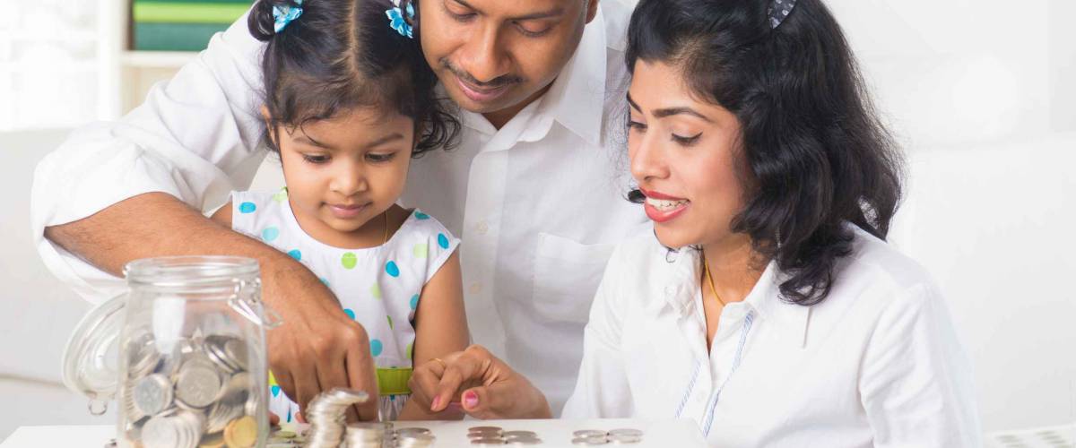 indian family teaching children on savings and financial planning