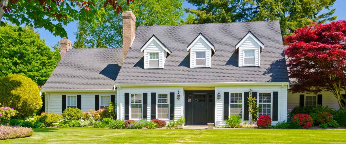 Custom built luxury house with nicely trimmed and landscaped front yard, lawn in a residential neighborhood. Vancouver Canada.