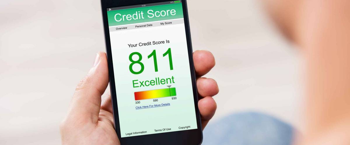 Man Holding Smartphone Showing Credit Score Rating on Screen