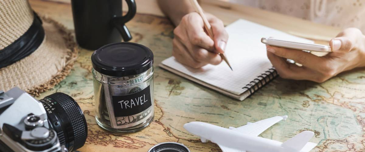 Young woman planning vacation trip and searching information or booking hotel on a smart phone