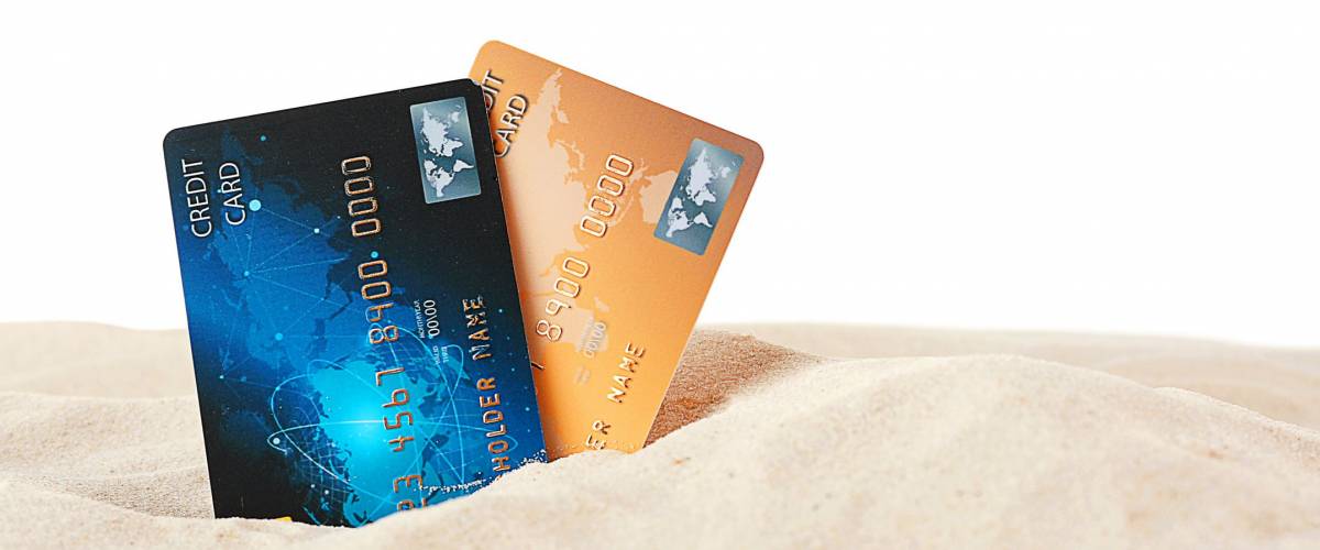 Credit cards in sand on white background
