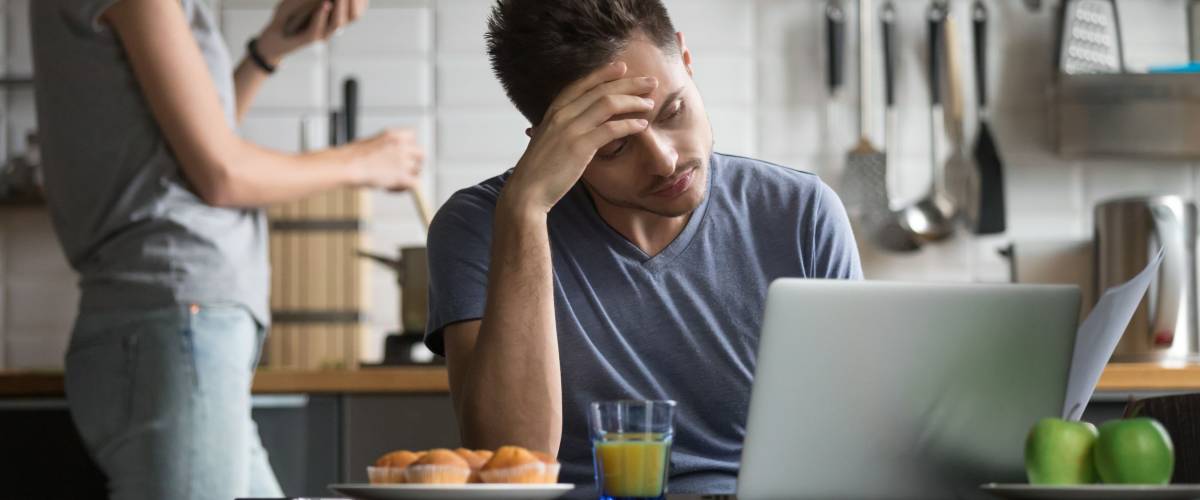 Upset man reviewing his debts