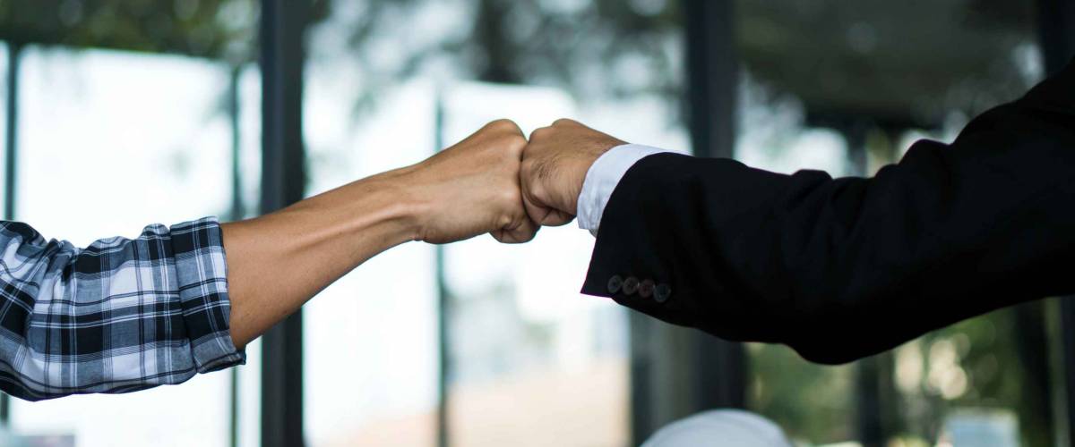 Hand bump Join Hands Partnership