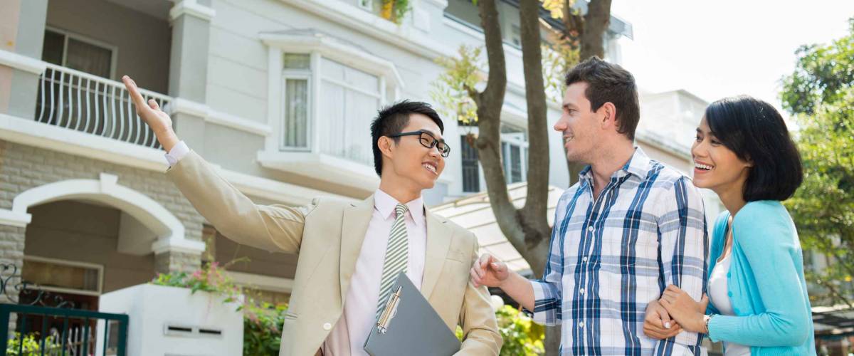 Estate agent showing a house to the young family