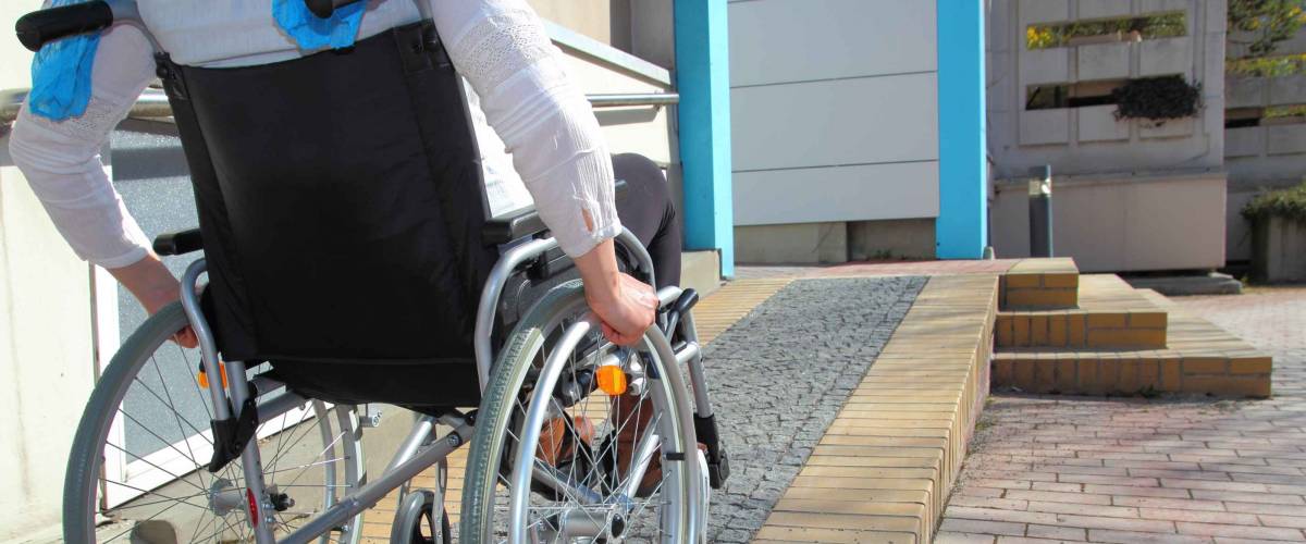 Woman in a wheelchair using a ramp