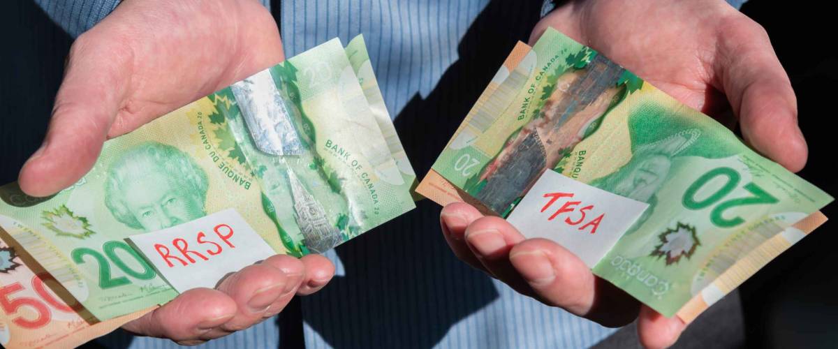 Close-up of man's hands holding Canadian cash for RRSP and TFSA investments